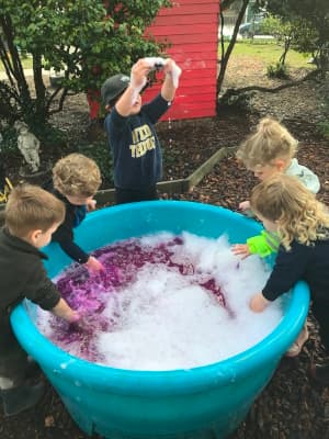 Preschoolers collaborating with blocks
